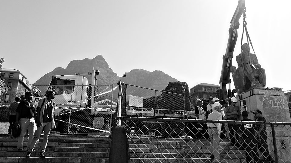 Photograph by Desmond Bowles of the removal of the statue of Cecil Rhodes from the campus of the University of Cape Town, 9 April 2015, via Wikimedia Commons.