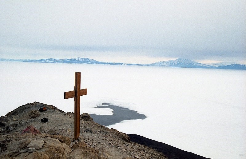 A cross in front of a polar landscape.