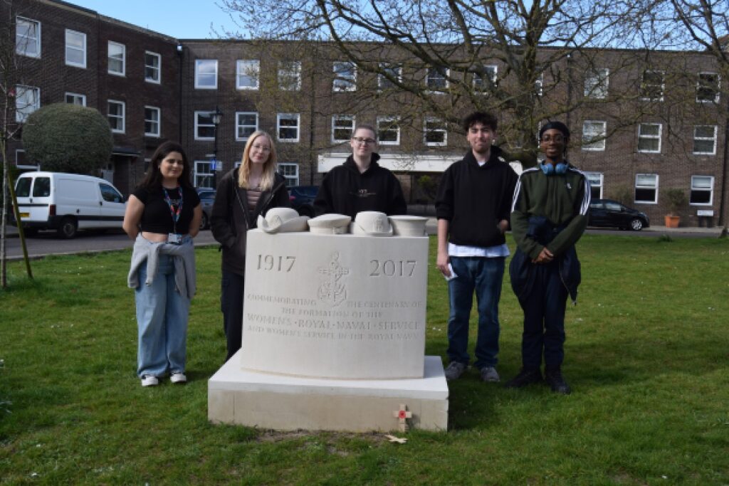 Photograph of Sofia, Charlie, Magdalena, Lewis, Ifa in front of a memorial outside Portsmouth Cathedral